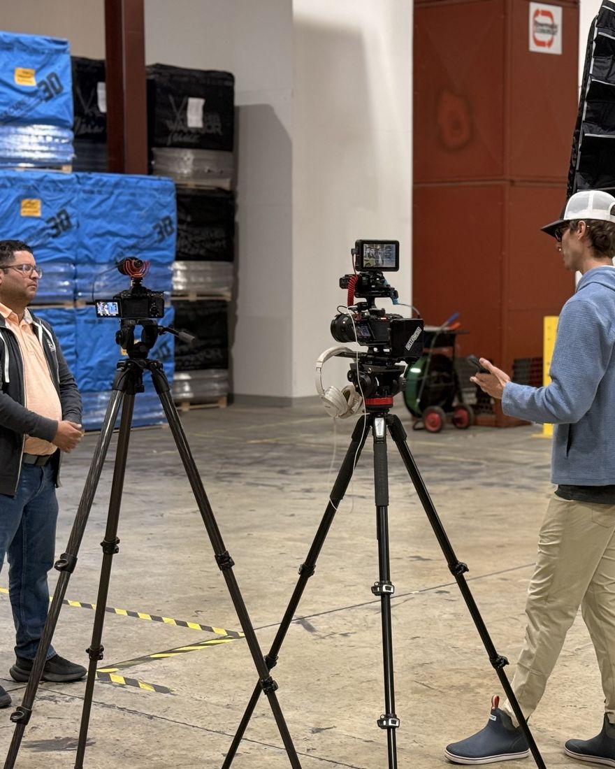 Two camera setups being prepared for a West45 Media shoot in a warehouse